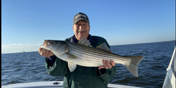 Big Striped Bass Smile at Maryland Fishing Charter